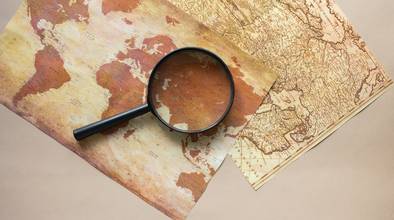 Magnifying glass placed on maps