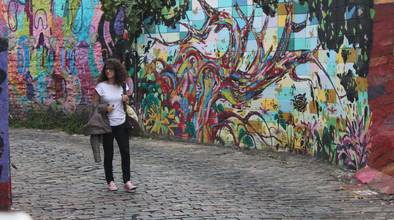 Frau vor buntbemalter Wand in Brasilien