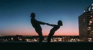 Two People dancing on Rooftop at night