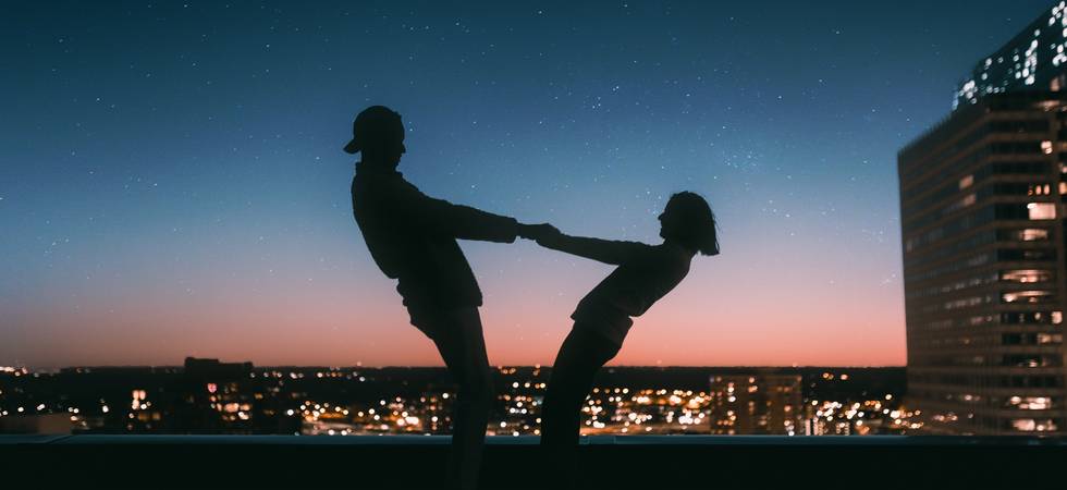 Two People dancing on Rooftop at night