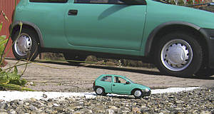 ein grünes Auto, das im Vordergrund in klein nochmal abgebildet ist